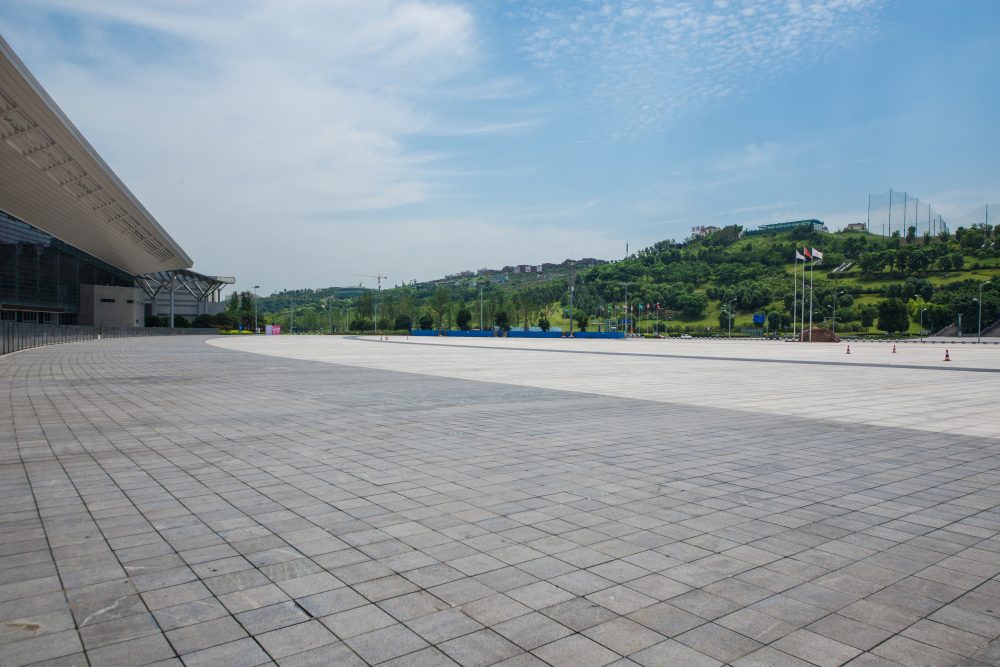 Large paved forecourt under a clear sky