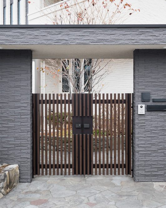 Timber and steel driveway gates on a modern house