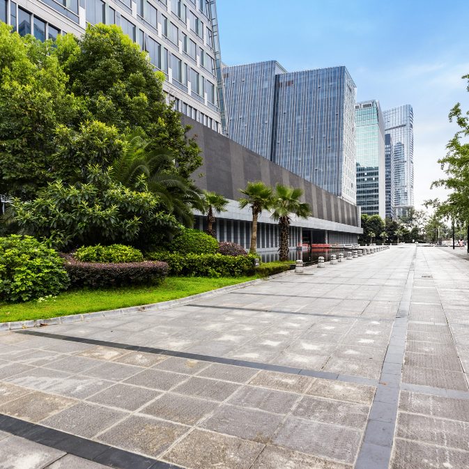 Paved path running through grass